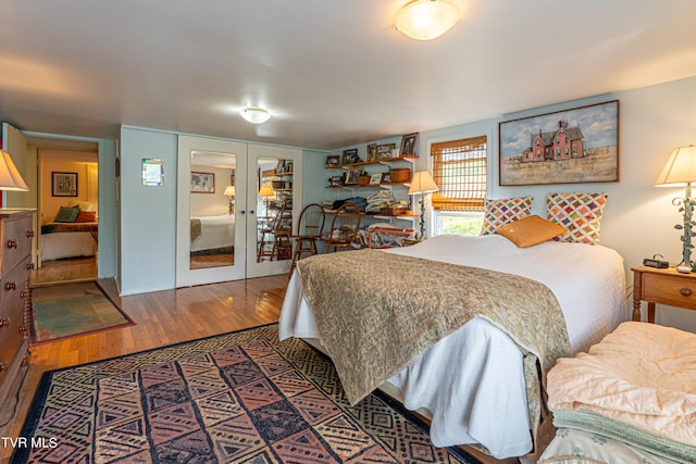 bedroom featuring french doors and wood finished floors