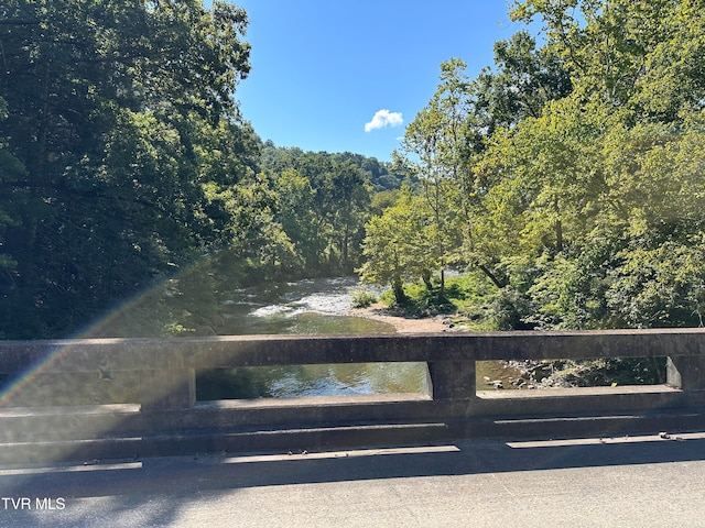 view of gate featuring a forest view