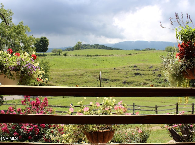 view of yard featuring fence and a rural view