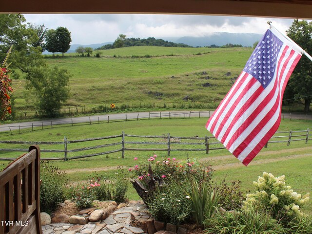 view of yard featuring fence and a rural view