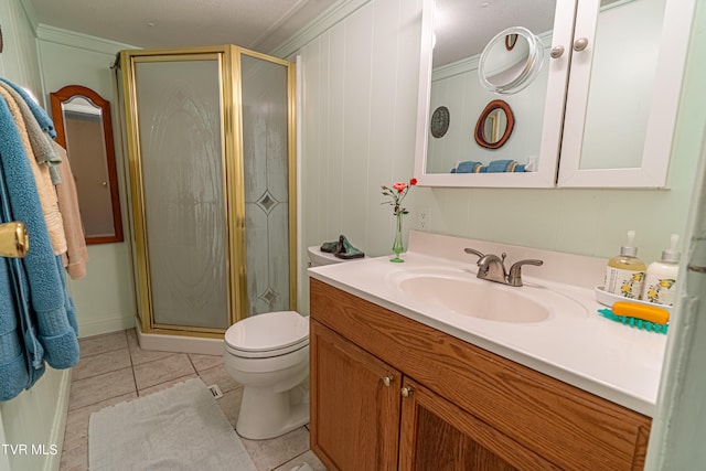 bathroom with crown molding, tile patterned flooring, vanity, toilet, and a stall shower