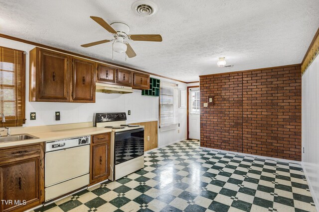 kitchen with ceiling fan, crown molding, brick wall, light tile patterned floors, and white appliances