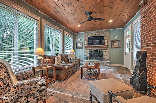 living room with wood ceiling, ceiling fan, and a fireplace