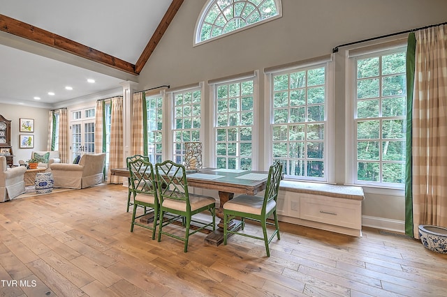 interior space with beam ceiling, high vaulted ceiling, and light hardwood / wood-style flooring