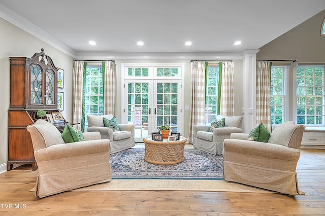 sunroom featuring decorative columns and french doors