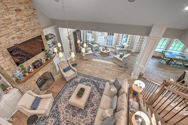 living room with hardwood / wood-style floors, plenty of natural light, and a brick fireplace