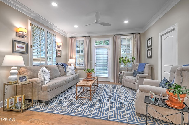 living room featuring hardwood / wood-style floors, crown molding, and ceiling fan