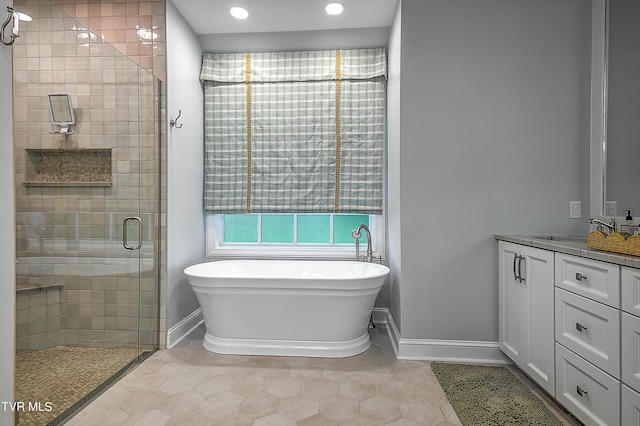 bathroom featuring vanity and shower with separate bathtub