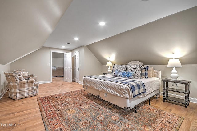 bedroom with lofted ceiling and hardwood / wood-style floors