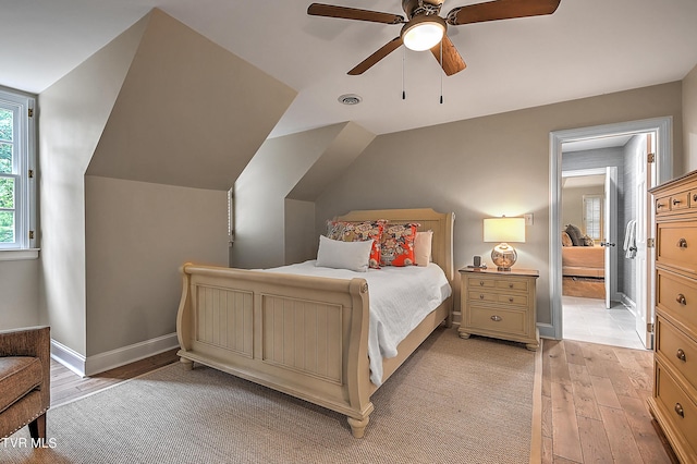 bedroom featuring lofted ceiling, ceiling fan, and light hardwood / wood-style flooring