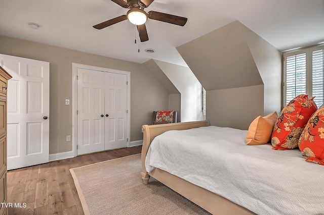 bedroom with ceiling fan, lofted ceiling, and light hardwood / wood-style floors