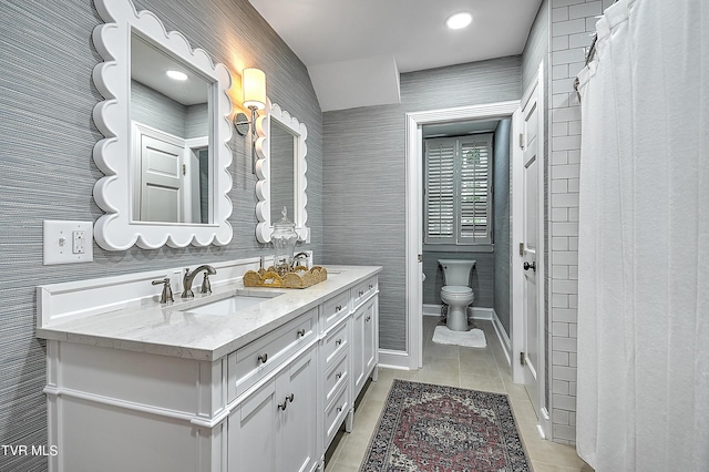 bathroom featuring a shower with shower curtain, vanity, toilet, and tile patterned flooring