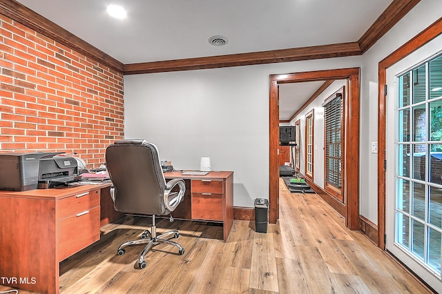 office with ornamental molding, brick wall, and light wood-type flooring