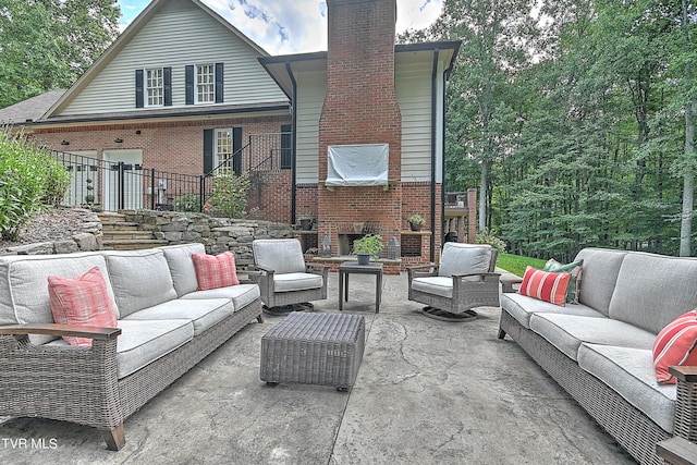 rear view of house with an outdoor living space and a patio area