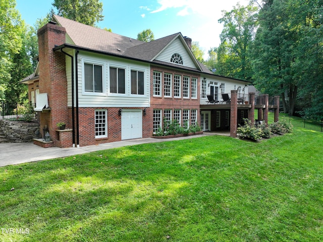 rear view of house with a yard, a patio area, and a deck