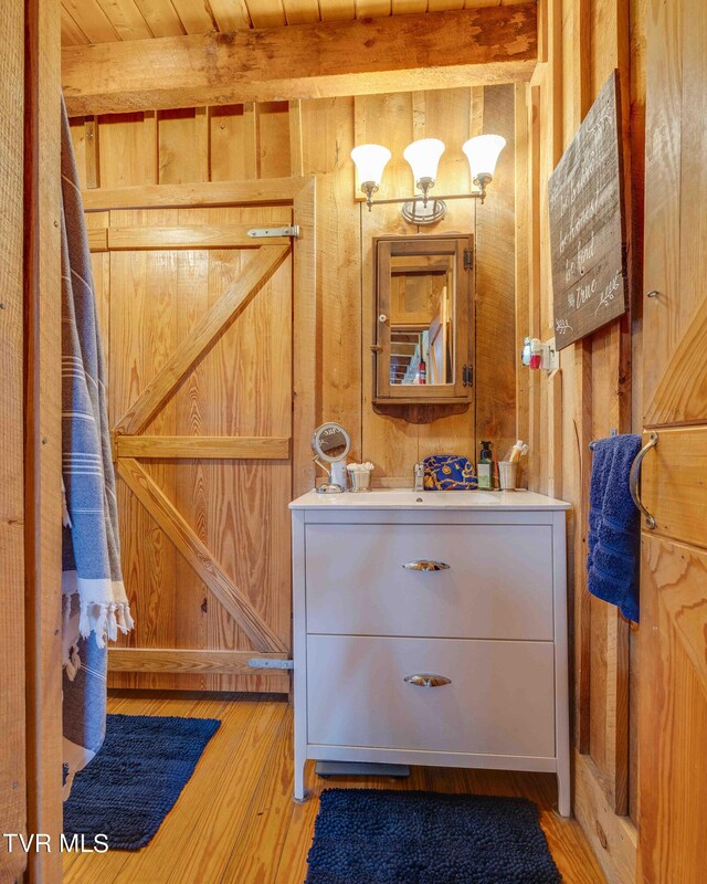 2390 W Allens Bridge Rd, Greeneville, TN 37743 - bathroom with wood walls, wood finished floors, and vanity