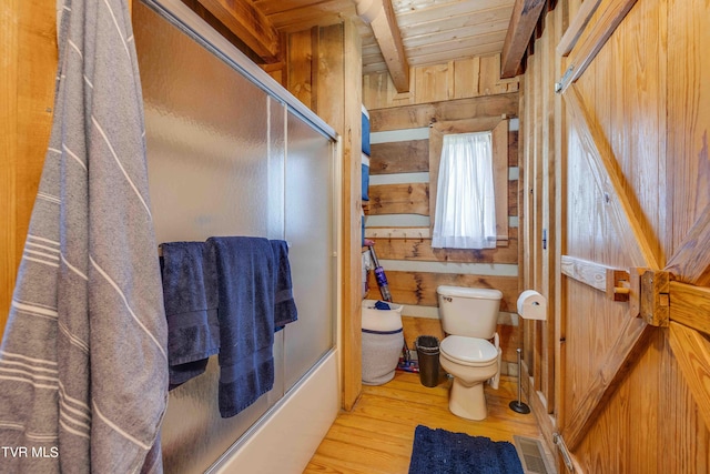 2390 W Allens Bridge Rd, Greeneville, TN 37743 - full bathroom with wood finished floors, toilet, wooden walls, wood ceiling, and bath / shower combo with glass door