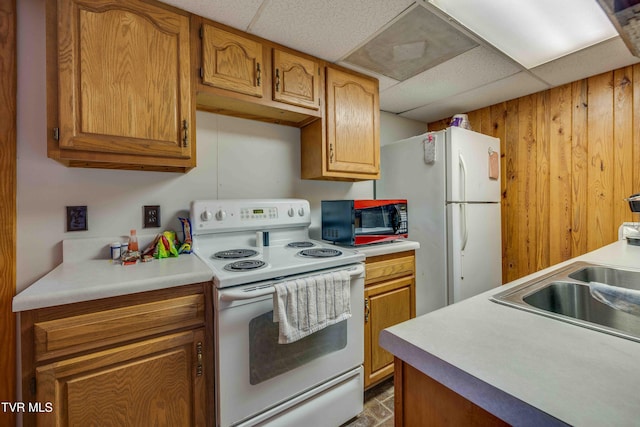 2390 W Allens Bridge Rd, Greeneville, TN 37743 - kitchen featuring white appliances, a drop ceiling, light countertops, a sink, and brown cabinetry