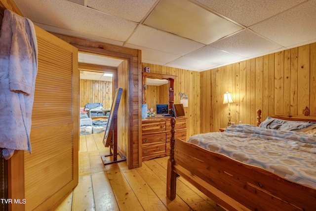 2390 W Allens Bridge Rd, Greeneville, TN 37743 - bedroom featuring light wood-style flooring, wooden walls, and a paneled ceiling