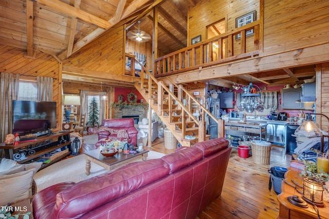 2390 W Allens Bridge Rd, Greeneville, TN 37743 - living room with wooden walls, beam ceiling, hardwood / wood-style flooring, stairway, and wooden ceiling