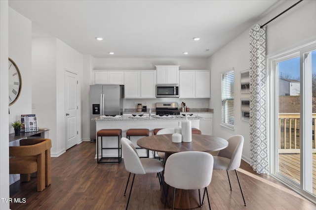 dining room with dark hardwood / wood-style floors