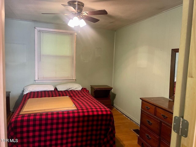 bedroom with ceiling fan and wood finished floors