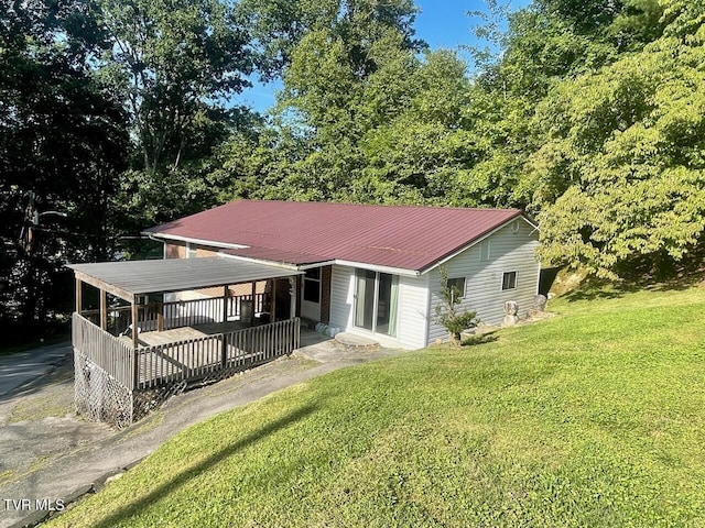 view of front facade with metal roof and a front yard