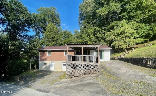 ranch-style home with aphalt driveway and brick siding