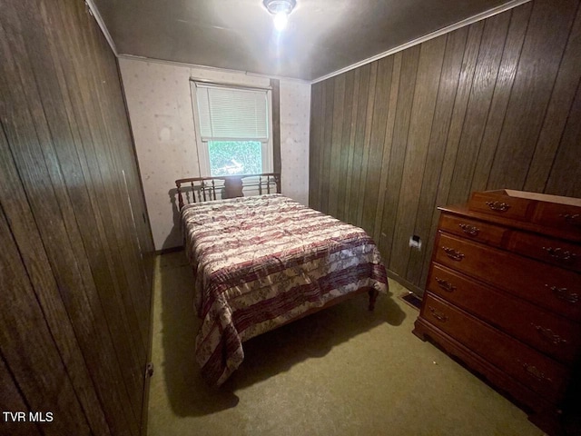 bedroom featuring light carpet and wood walls