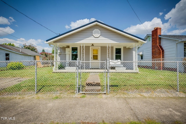 bungalow featuring covered porch and a front lawn