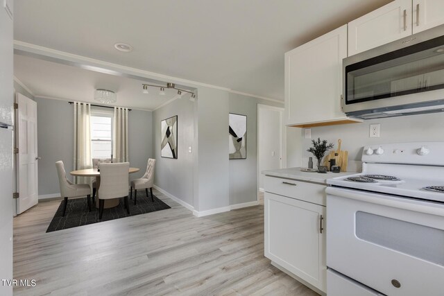 kitchen featuring light wood-type flooring, white electric stove, and white cabinetry