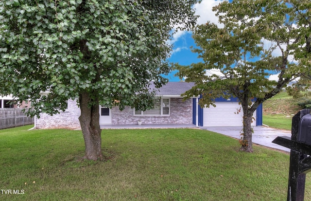 view of front of property featuring concrete driveway, an attached garage, fence, and a front lawn