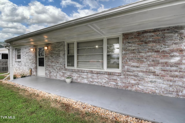 exterior space featuring brick siding