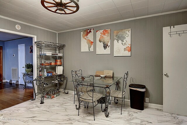 dining space featuring ornamental molding and wood-type flooring