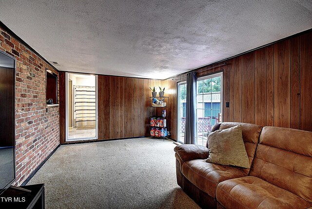 unfurnished living room featuring wooden walls, a textured ceiling, and carpet floors