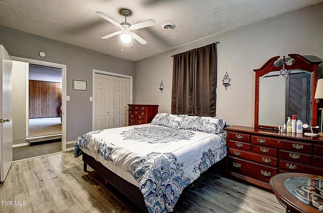 bedroom featuring ceiling fan, wood-type flooring, and a closet