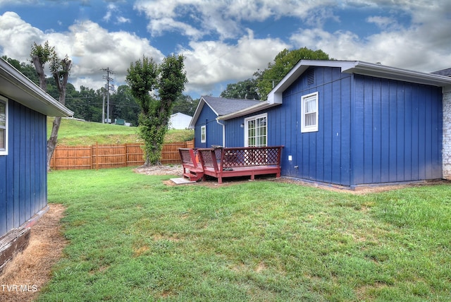 view of yard with a wooden deck and fence