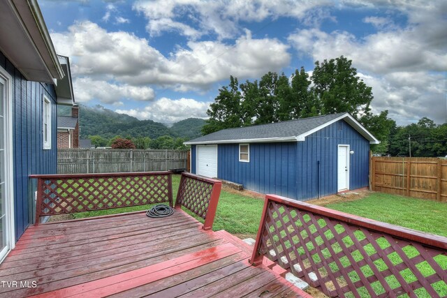 wooden deck featuring a yard and an outdoor structure