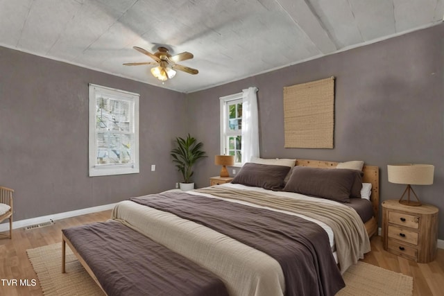 bedroom with light wood-type flooring and ceiling fan