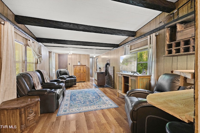 living room featuring light wood-type flooring, vaulted ceiling with beams, and wooden walls