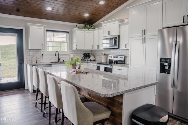 kitchen with a kitchen island, sink, white cabinets, stainless steel appliances, and wooden ceiling