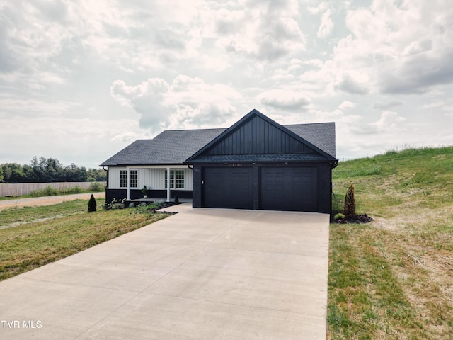 view of front of property with a garage and a front yard