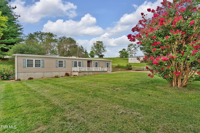 exterior space with a deck and a front yard