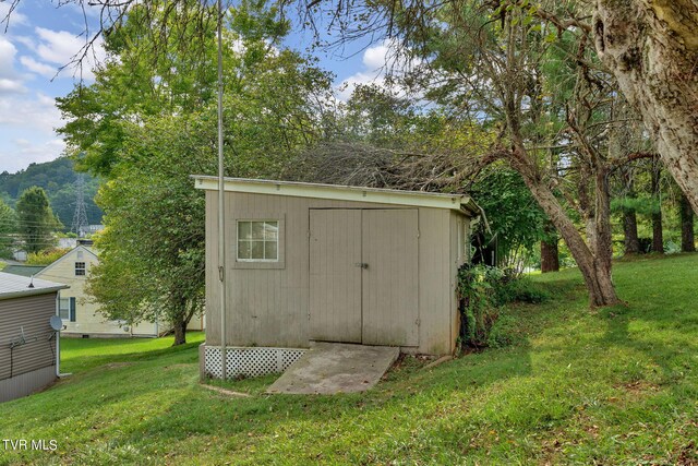 view of outbuilding with a yard