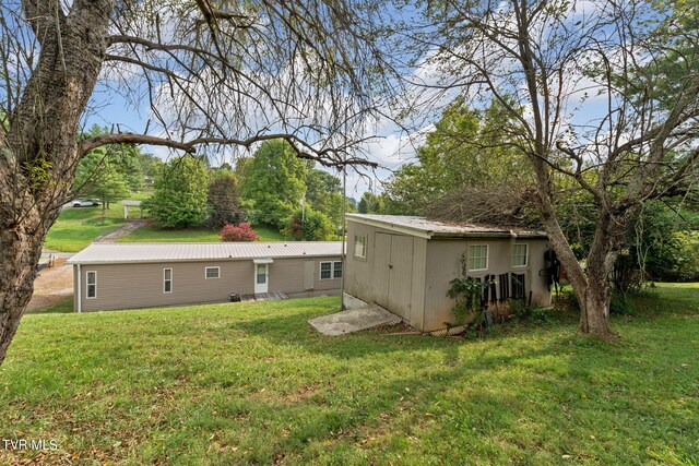 rear view of property featuring a yard