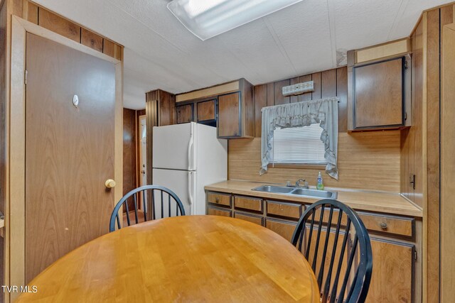 kitchen featuring sink and white fridge