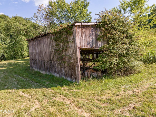 view of outbuilding featuring a yard