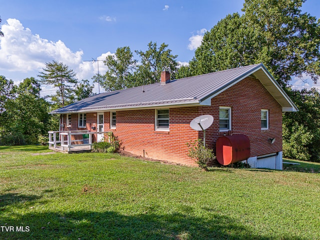 rear view of property featuring a lawn