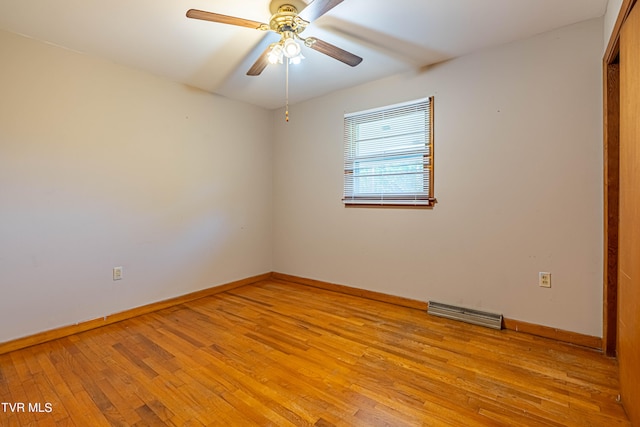 empty room with ceiling fan and light hardwood / wood-style flooring