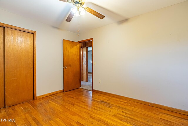 unfurnished bedroom featuring a closet, ceiling fan, and wood-type flooring